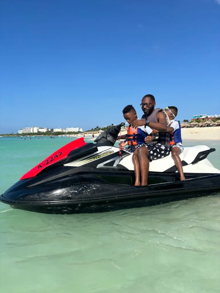 My husband and twins getting ready to explore Eagle Beach- via water on a jet ski.